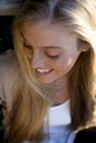 Australian Beauty with Long Blond Hair Sitting looking down.