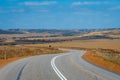 Australian bush road curving through dry landscape with corn fields Royalty Free Stock Photo
