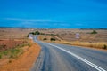 Australian bush road leading through dry landscape and farmland with speed limit Royalty Free Stock Photo