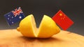 Australian and Chinese flags on a cut lemon. International relations sour