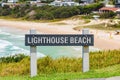 Australian coast, Lighthouse Beach information board with the name of the beach at the entrance to the sandy beach