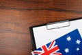 Australian document, mockup for text on clipboard, white sheet of paper in a folder for notes with Australian flag Royalty Free Stock Photo