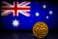 Australian dollar coin isolated on Australia flag background with space for copy text. One dollar coin 1995 Australian currency. Royalty Free Stock Photo