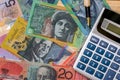 Australian dollars, pen and calculator on wooden background Royalty Free Stock Photo