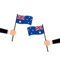 Australian flag concept. Hand hold small flag on white background top view copy space