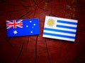 Australian flag with Uruguaian flag on a tree stump isolated Royalty Free Stock Photo