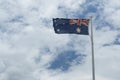 Australian flags against cloudy sky