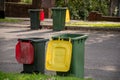 Australian garbage wheelie bins with colourful lids for general and recycling household waste lined up on the street kerbside