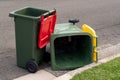 Australian garbage wheelie bins with colourful lids for general and recycling household waste on the street kerbside