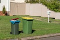 Australian garbage wheelie bins with colourful lids for general and recycling household waste on the street kerbside