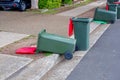 Australian garbage wheelie bins red lids for general waster stay and lie down on the street kerbside