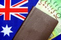 100 Australian green cash money with passport on Australia flag background. Royalty Free Stock Photo