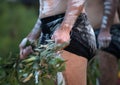 Australian Indigenous Ceremony, man's hand with branches, start a dance for a ritual rite at a community event