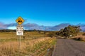 Australian outback road with school bus stop sign Royalty Free Stock Photo