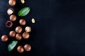 Australian peeled and whole macadamia nut with green leaves