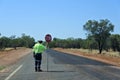 Australian road worker holding a stop sign on an outback road Royalty Free Stock Photo