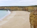 Australian sandy beach and yellow rocks Royalty Free Stock Photo