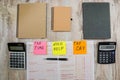 Australian tax forms, calculator, notebooks and pen on the table.