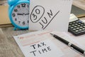 Australian tax forms, calculator, notebooks and pen on the table.