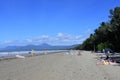 Australian tourists sunbathing on Port Douglas main. beach in the tropical far north Queensland Australia