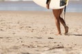 Australian Woman surfer walking along the Beach whit her Surfboard. Noosa, Queensland, Australia Royalty Free Stock Photo