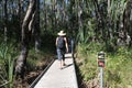 Australian woman tourist passing by a beware for the crocodiles sign Northern Territory Australia