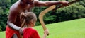 Australians aboriginals man teaches a young girl how to throw a Royalty Free Stock Photo