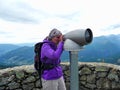 Austria. Alps. Point of observation. Telescope. The girl is looking through the telescope.