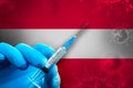 Austria Covid-19 Vaccination Campaign. Hand in a blue rubber glove holds a syringe with covid-19 virus vaccine in front of Austria Royalty Free Stock Photo