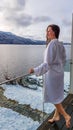 Austria - A girl in a white bathrobe standing on the balcony in winter