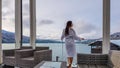 Austria - A girl in a white bathrobe standing on the balcony in winter