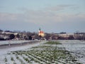 Austria, snow-covered fields and tiny village in winter