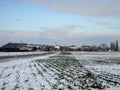 Austria, snow-covered fields and tiny village in winter