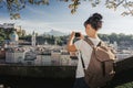 Austria. Salzburg. Young girl tourist taking pictures on mobile