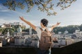 Austria. Salzburg. A young tourist girl with arms raised