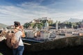 Austria. Salzburg. A young tourist girl takes pictures Royalty Free Stock Photo