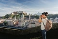 Austria. Salzburg. A young tourist girl takes pictures Royalty Free Stock Photo