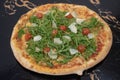beautiful closeup pizza image and mozzarella, fresh tomatoes, arugula, grana. austria, vienna - 25 April 2023: