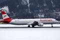 Austrian Airlines small jet on the snowy apron, Innsbruck Airport INN Royalty Free Stock Photo