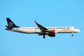 Star Alliance Austrian Airlines plane flying up in the sky Royalty Free Stock Photo