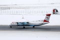 Austrian Airlines plane taxiing in Innsbruck Airport, INN snow Royalty Free Stock Photo