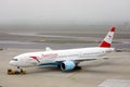 Austrian Airlines plane doing taxi on taxiway being towed Royalty Free Stock Photo