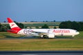 Austrian Airlines plane doing taxi on taxiway, 60 years livery