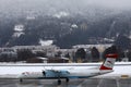 Austrian Airlines plane landing on snowy runway, Innsbruck Airport Royalty Free Stock Photo