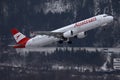 Austrian Airlines plane landing on snowy runway, Innsbruck Airport Royalty Free Stock Photo