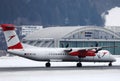 Austrian Airlines plane landing on snowy runway, Innsbruck Airport Royalty Free Stock Photo