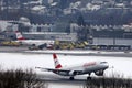 Austrian Airlines plane landing on snowy runway, Innsbruck Airport Royalty Free Stock Photo