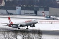 Austrian Airlines plane landing on snowy runway, Innsbruck Airport Royalty Free Stock Photo