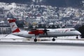 Austrian Airlines plane landing on snowy runway, Innsbruck Airport Royalty Free Stock Photo