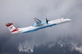 Austrian Airlines plane taking off from Innsbruck Airport Royalty Free Stock Photo